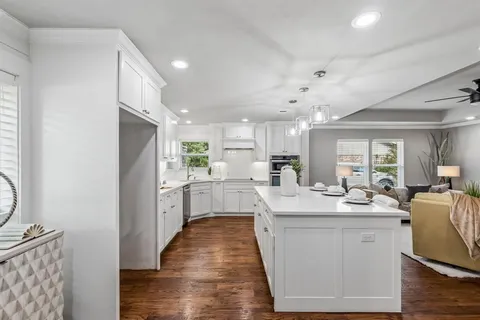 a kitchen with counter top space sink stove and refrigerator