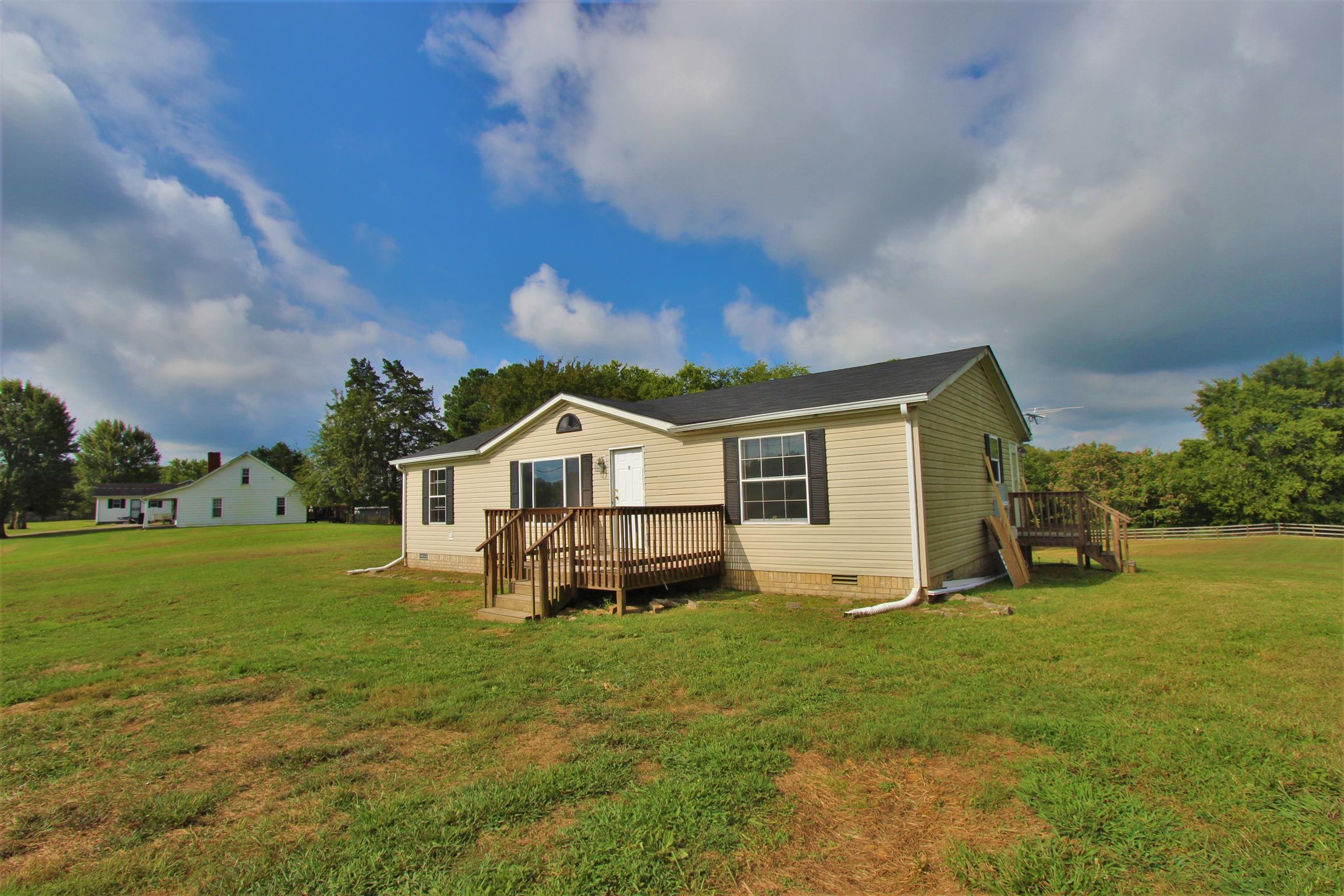4430 Beasleys Bend Road Lebanon, TN 37087 - Photo 1 of 16 a front view of a house with a yard table and chairs