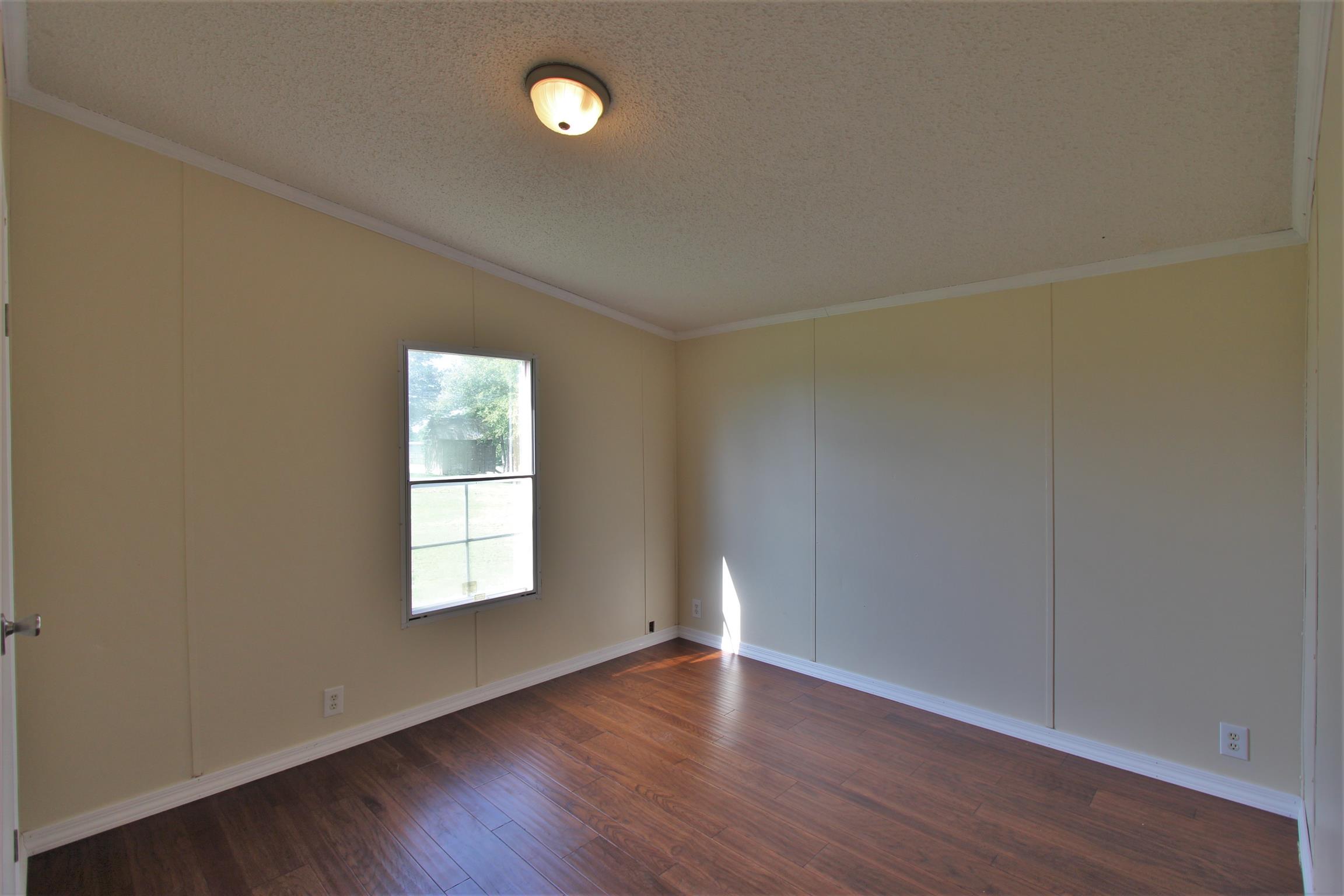 4430 Beasleys Bend Road Lebanon, TN 37087 - Photo 14 of 16 an empty room with wooden floor and windows