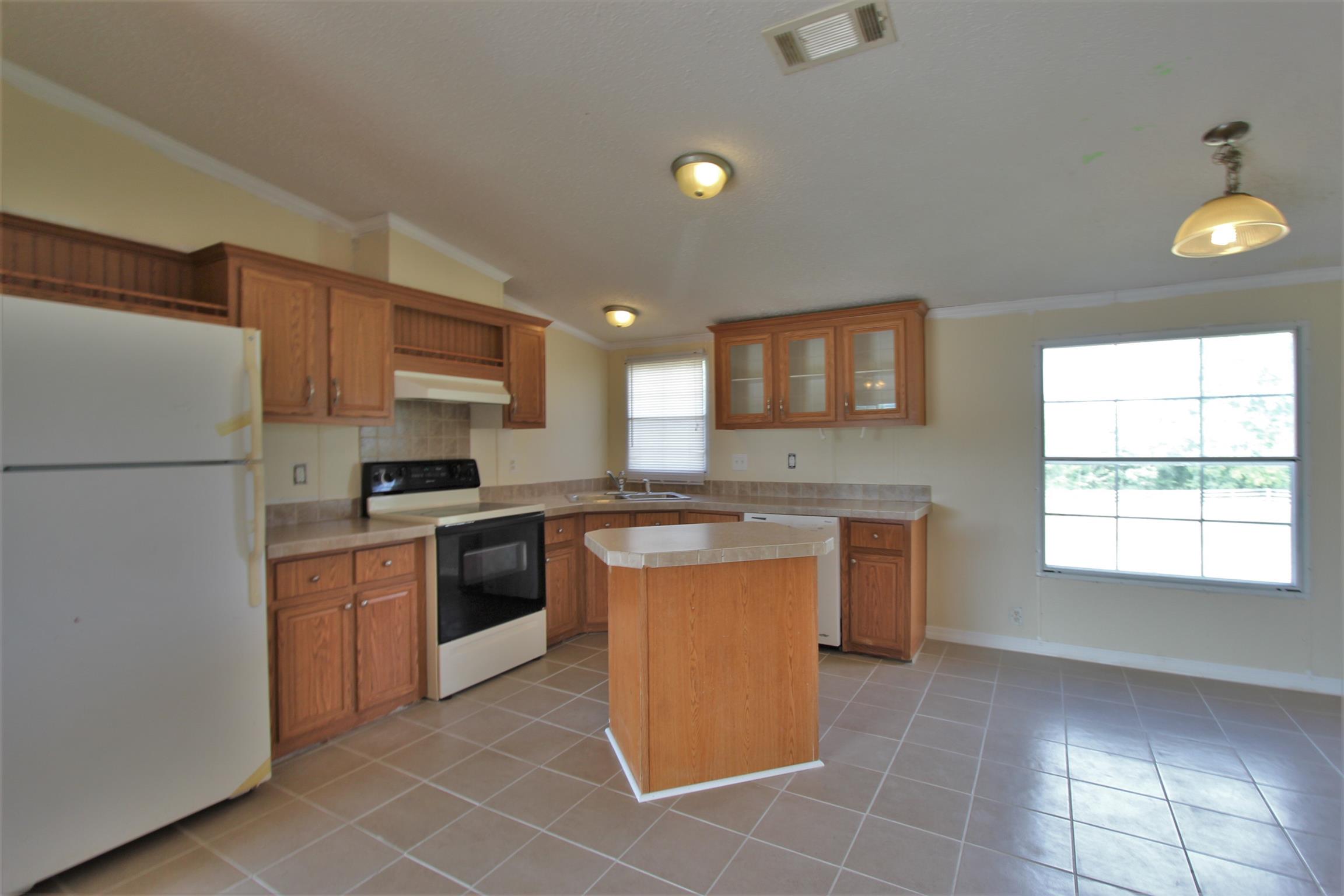 4430 Beasleys Bend Road Lebanon, TN 37087 - Photo 6 of 16 a kitchen with a refrigerator a oven and a stove top oven