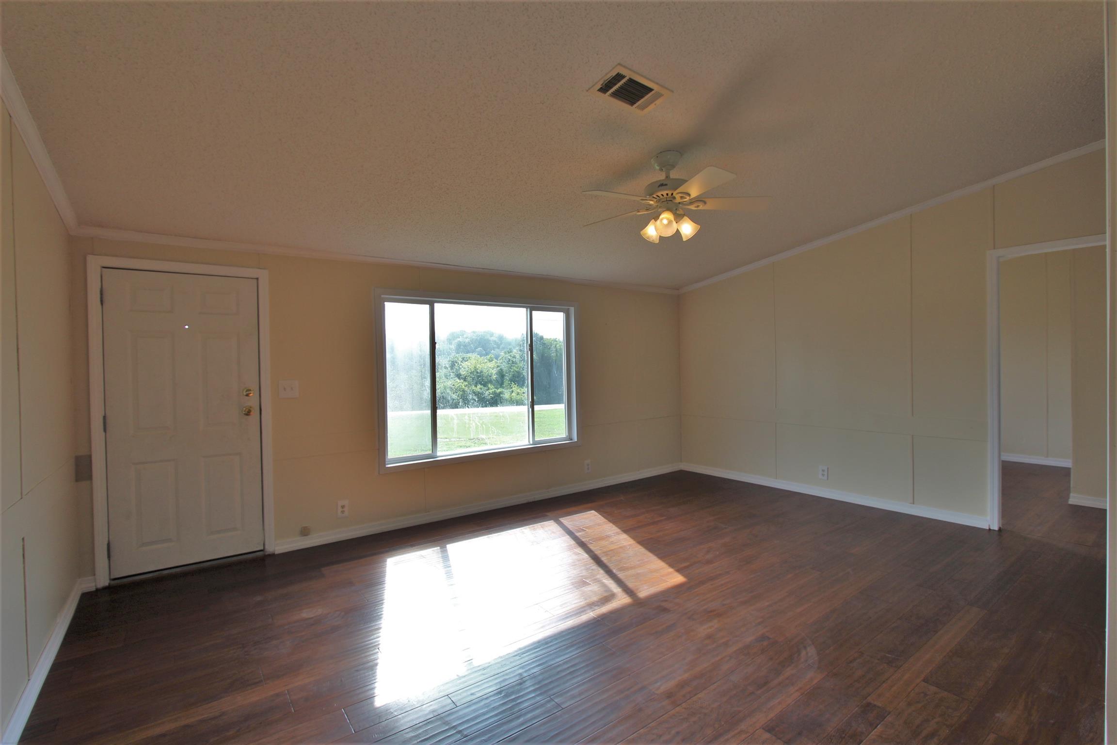 4430 Beasleys Bend Road Lebanon, TN 37087 - Photo 8 of 16 an empty room with wooden floor and windows