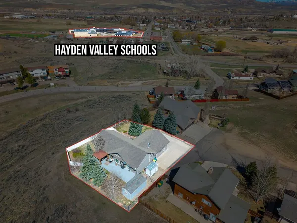 an aerial view of a house with a yard