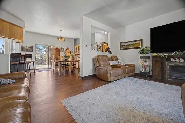 a dining room with furniture a window and wooden floor