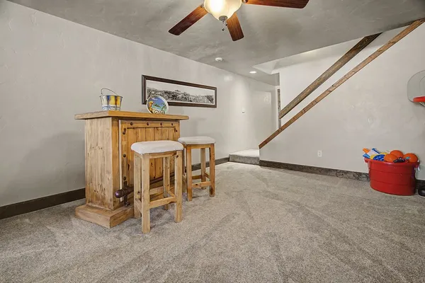 a living room with furniture and a ceiling fan