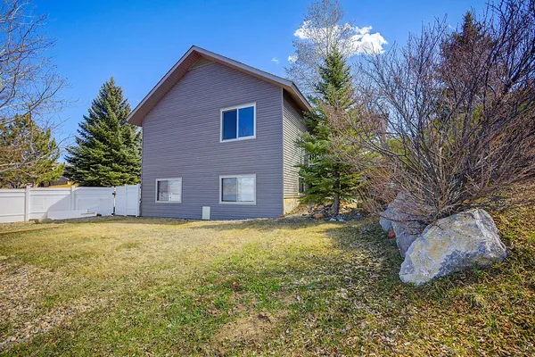 a house that has a tree in front of it