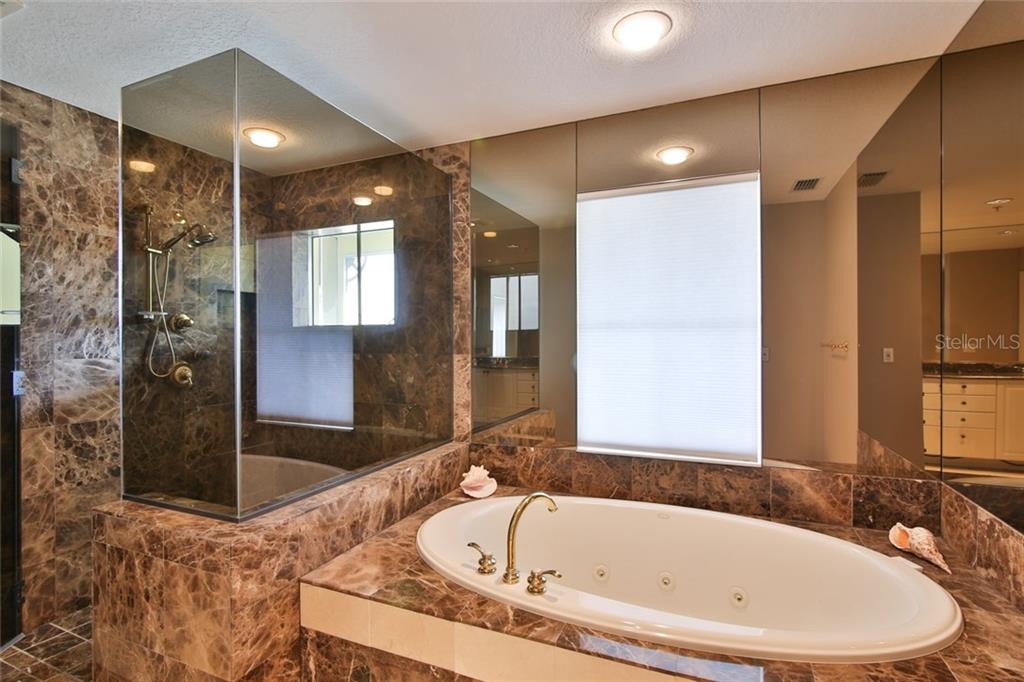 1310 Old Stickney Point Road, Unit E21 Sarasota, FL 34242 - Photo 16 of 25 Luxurious master bath w/ large jetted tub and abundance of marble