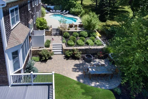 an aerial view of a house with a yard basket ball court and outdoor seating