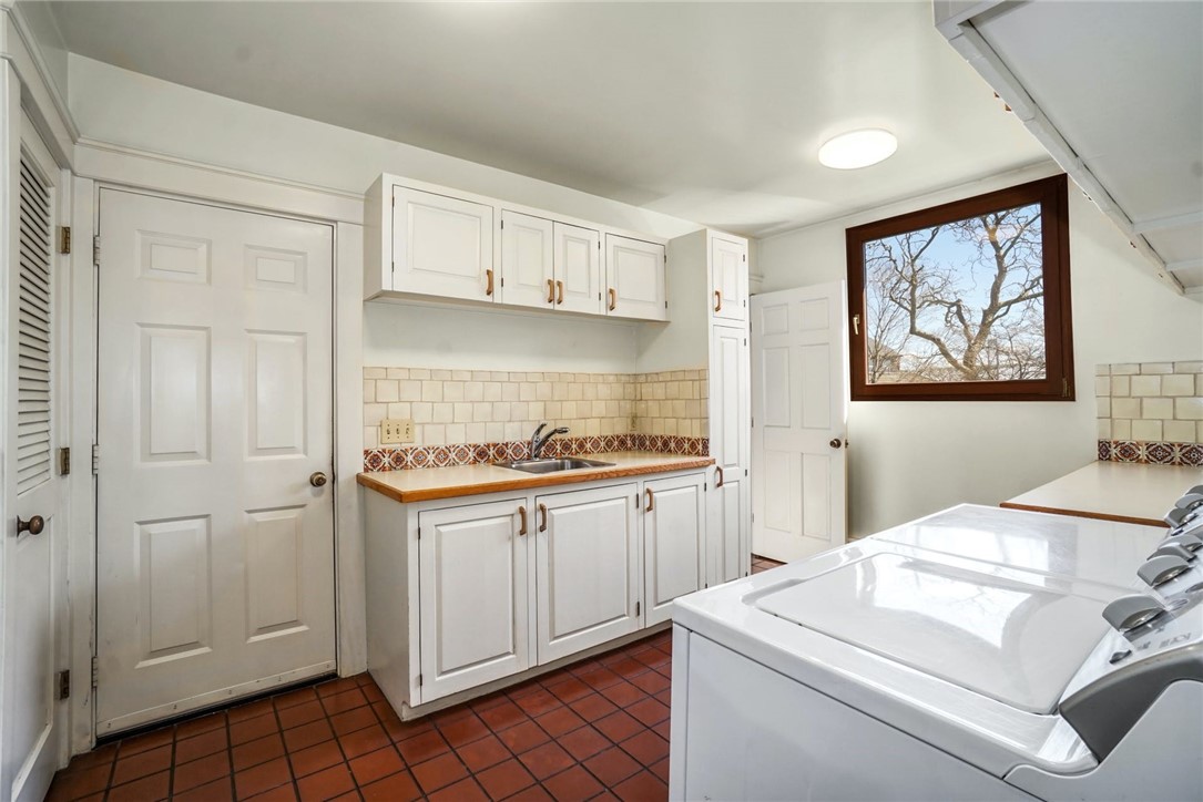 10 Emerson Road Jamestown, RI 02835 - Photo 16 of 31 Just off the Kitchen is a 13' x 9' Laundry Room and Pantry, with sink, and loads of storage space. The Garage is right through this door. Second door leads you to room above!