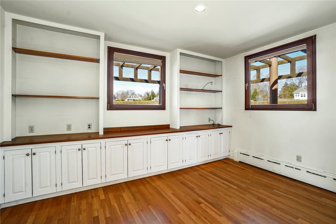 10 Emerson Road Jamestown, RI 02835 - Photo 17 of 31 There is also a first floor en Suite, with built ins, and a full Bath, although it could be used as an Office or Den. This room is 13' x 10'.