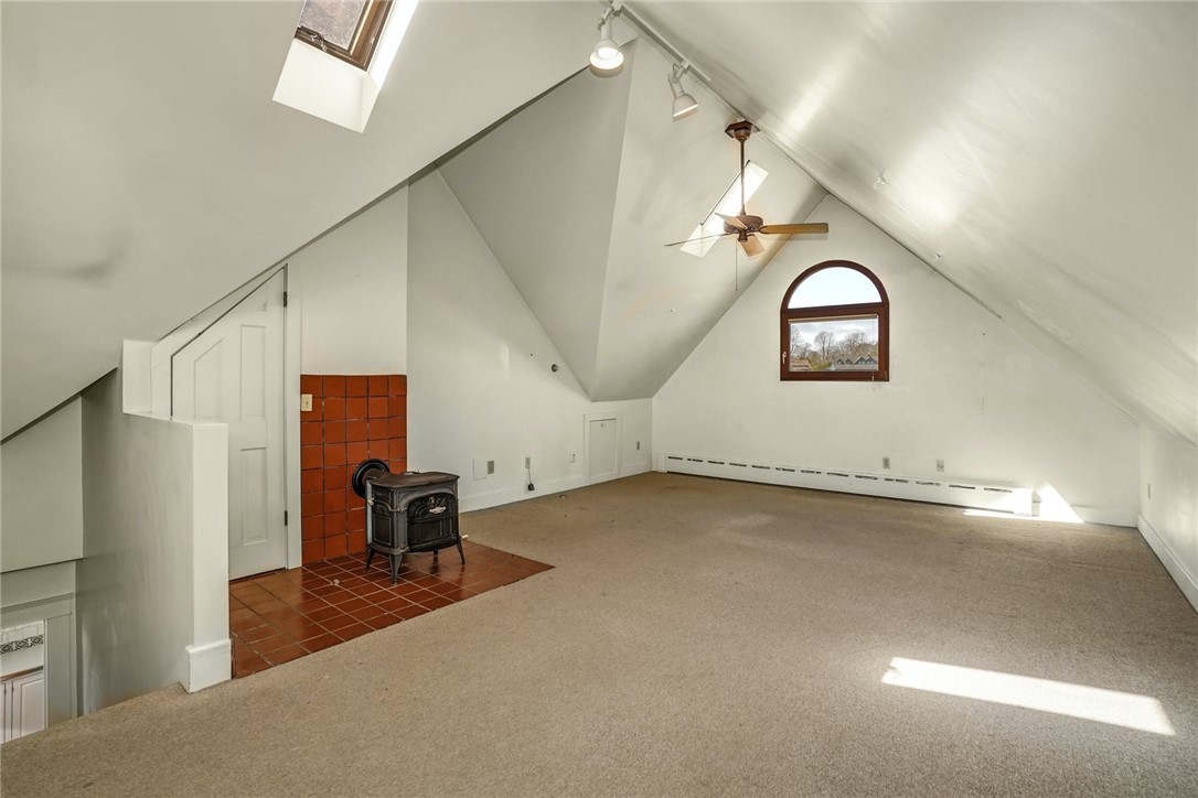 10 Emerson Road Jamestown, RI 02835 - Photo 27 of 31 This wonderful space is above the Garage, with its own zone of heat, and a woodstove. This space is 23' x 17'.