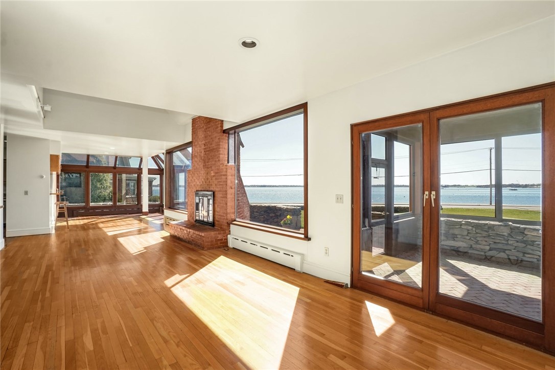 10 Emerson Road Jamestown, RI 02835 - Photo 8 of 31 Beautiful open concept Living Room and Dining Area capture the amazing views. Through these double doors is the Screened in Porch.