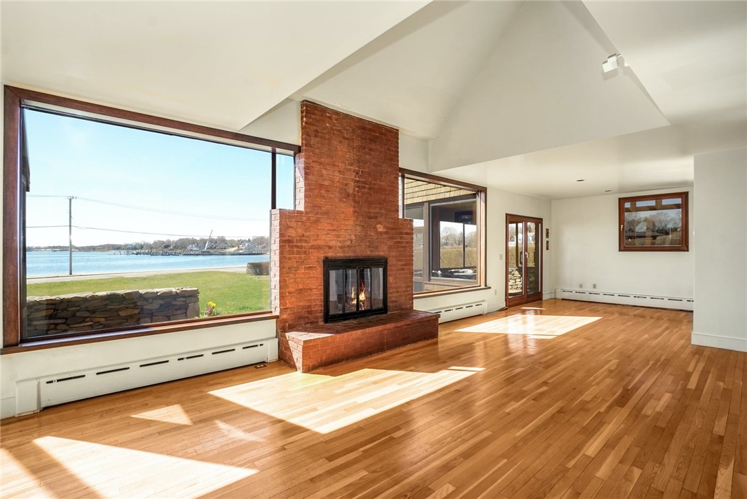 10 Emerson Road Jamestown, RI 02835 - Photo 10 of 31 Floor to ceiling windows flank the wood-burning Fireplace.