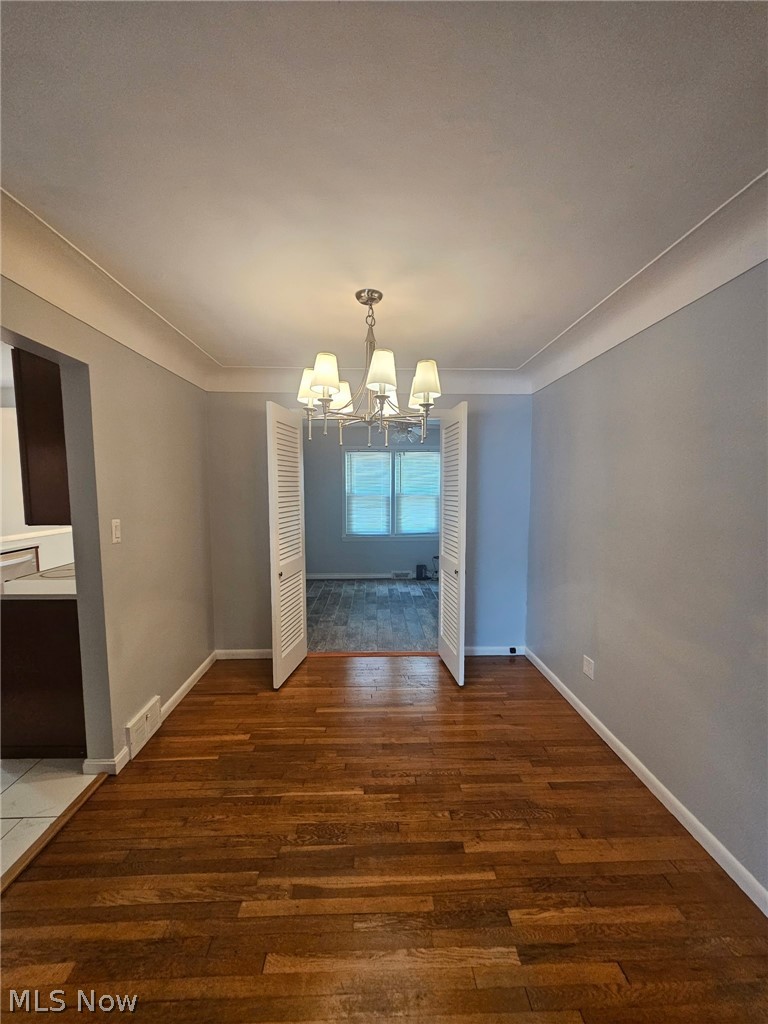 4237 Stonehaven Road South Euclid, OH 44121 - Photo 7 of 35 Wood-finish flooring, crown molding, and a polished chandelier