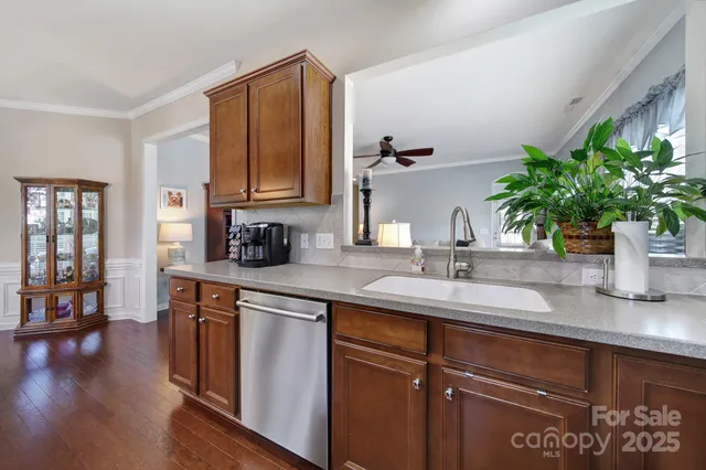 a kitchen with sink and wooden floor