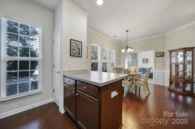 a kitchen with granite countertop a stove cabinets and wooden floor