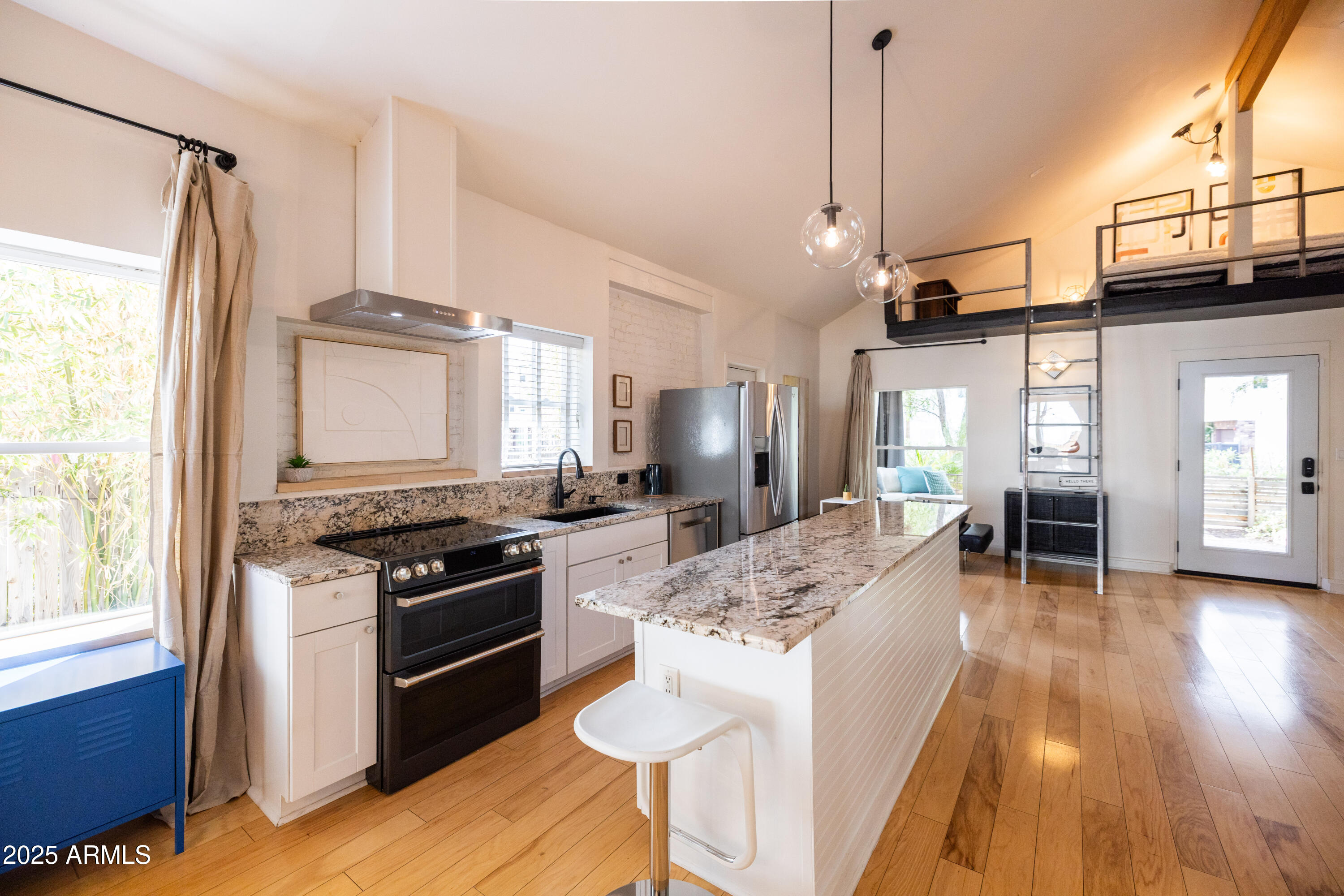 a kitchen with stainless steel appliances granite countertop a stove and refrigerator