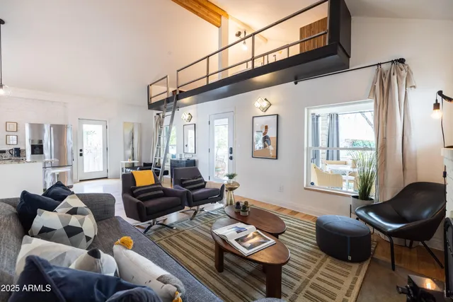 a view of a kitchen with dining table and stainless steel appliances