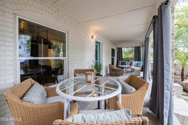 a living room with furniture a fireplace and window