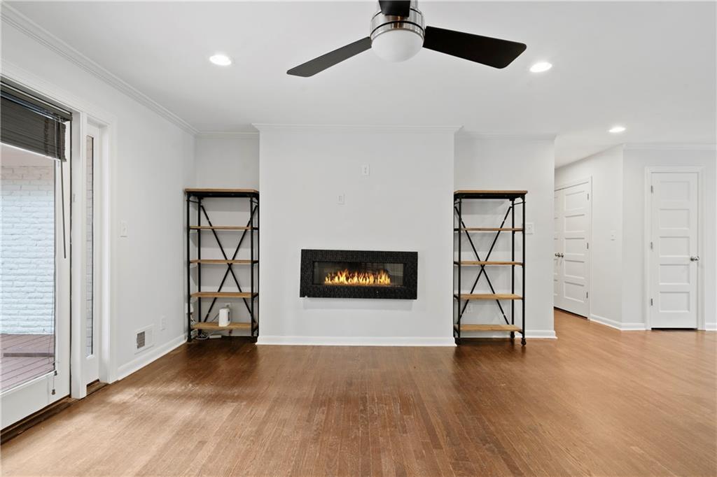 3363 Briarcliff Road Northeast Atlanta, GA 30345 - Photo 12 of 44 an empty room with wooden floor a ceiling fan and windows