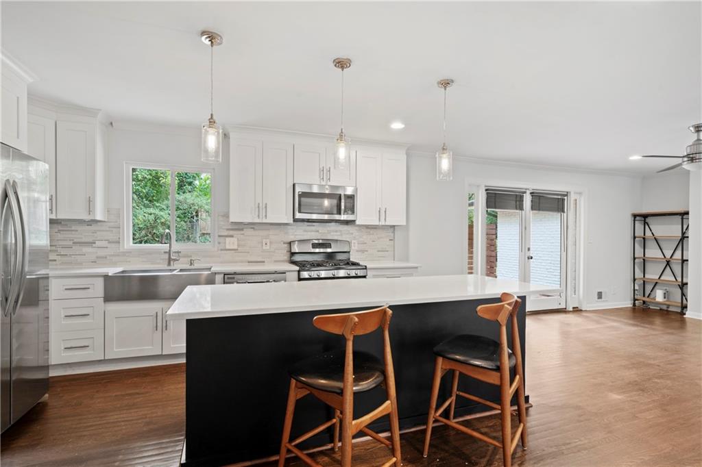 3363 Briarcliff Road Northeast Atlanta, GA 30345 - Photo 18 of 44 a kitchen with kitchen island granite countertop a sink counter and chairs