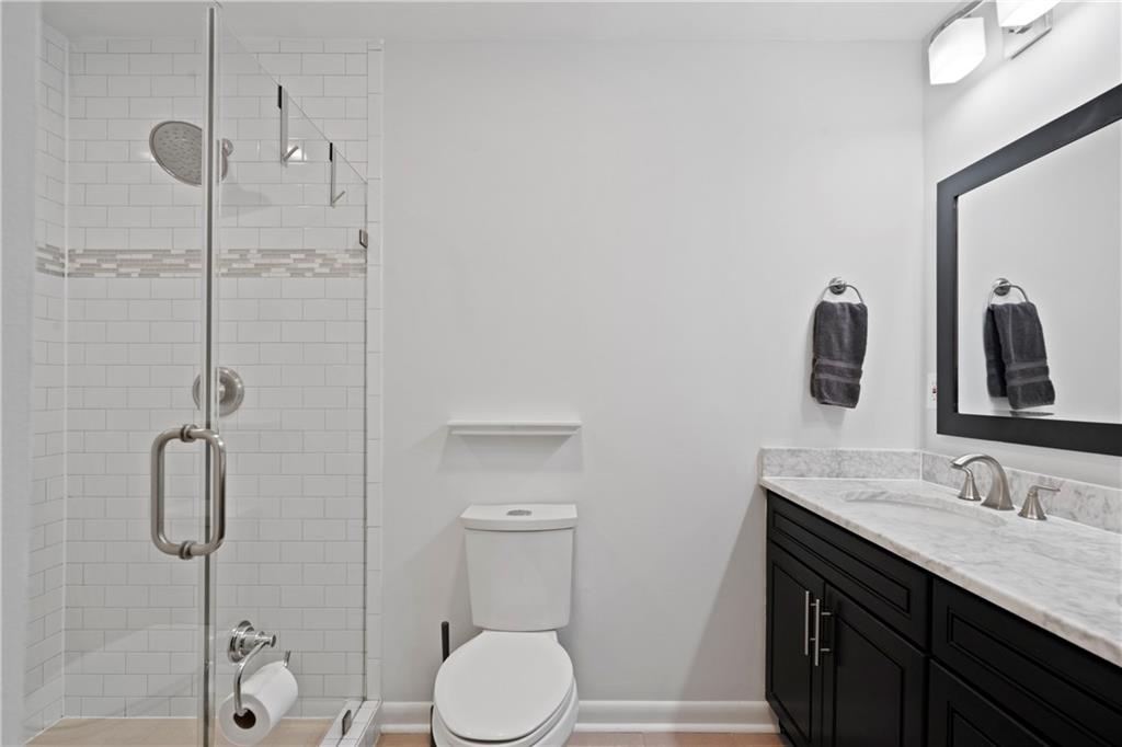 3363 Briarcliff Road Northeast Atlanta, GA 30345 - Photo 28 of 44 a bathroom with a granite countertop sink toilet and shower
