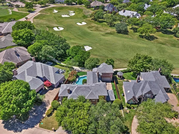 an aerial view of a house with garden space and street view