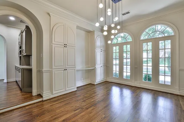 a kitchen with stainless steel appliances granite countertop a sink a oven and a hard wood floor