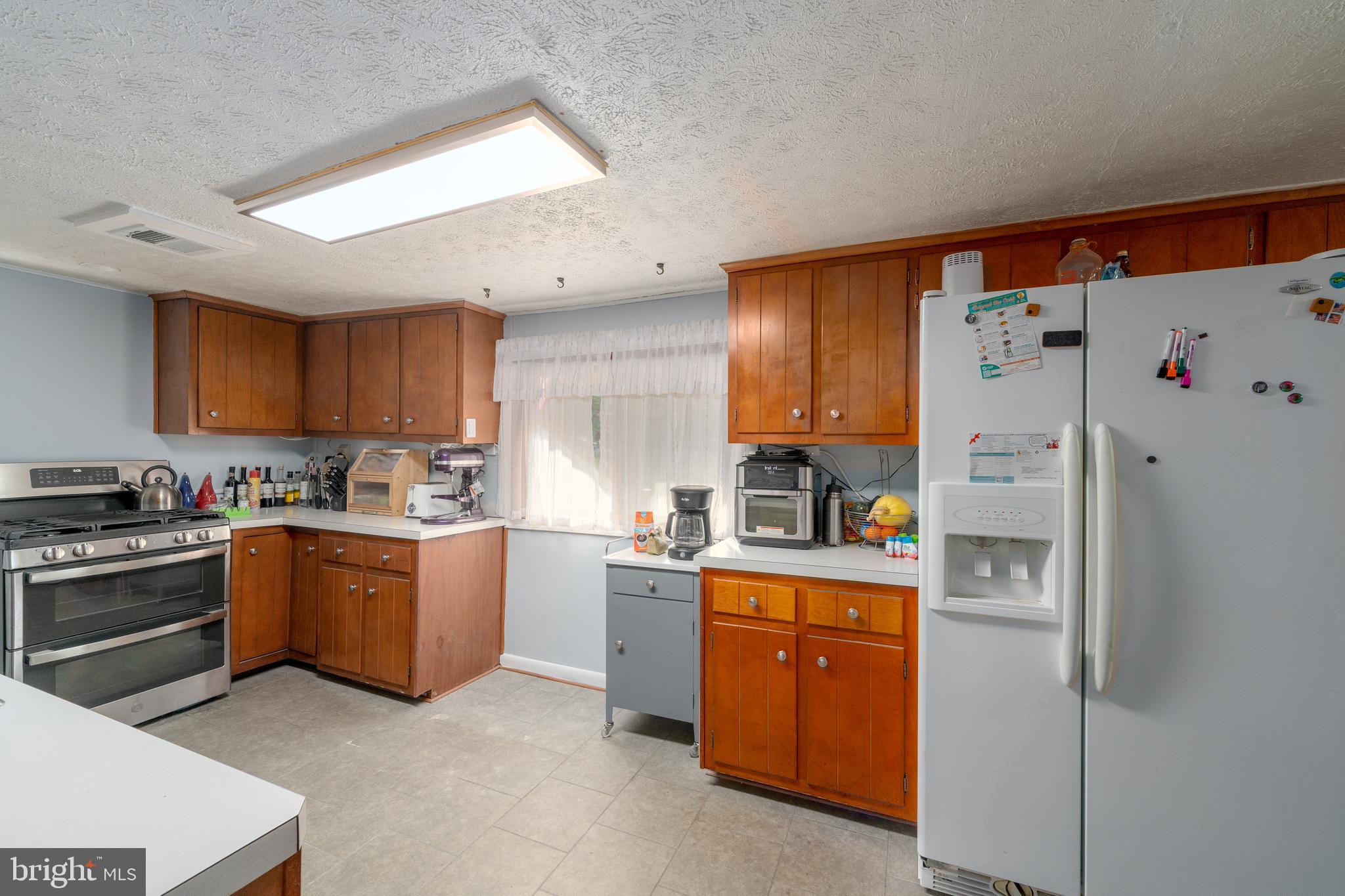 7875 Telegraph Road Severn, MD 21144 - Photo 3 of 25 a kitchen with stainless steel appliances granite countertop a refrigerator sink and stove