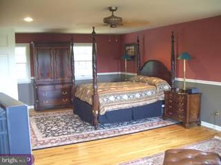 6775 Phillips Mill Road New Hope, PA 18938 - Photo 4 of 6 a bed sitting in a room next to a window