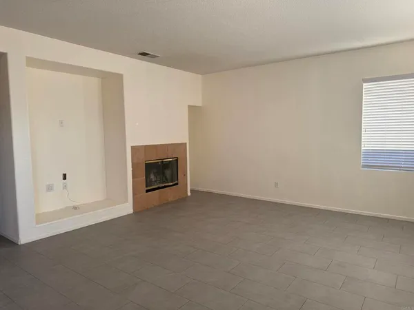 a view of empty room with a fireplace