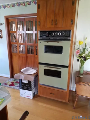 a stove top oven sitting inside of a kitchen