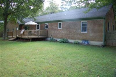 28 Deer Ridge Road Mashpee, MA 02649 - Photo 13 of 13 a front view of a house with a garden