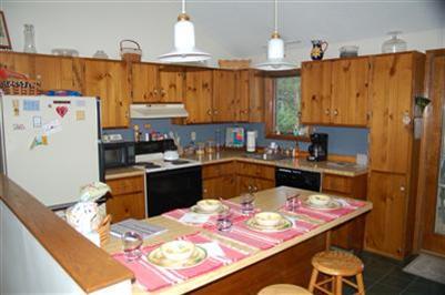 28 Deer Ridge Road Mashpee, MA 02649 - Photo 3 of 13 a kitchen with a refrigerator and a stove top oven