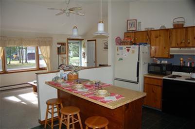 28 Deer Ridge Road Mashpee, MA 02649 - Photo 5 of 13 a living room with stainless steel appliances furniture a rug and a kitchen view