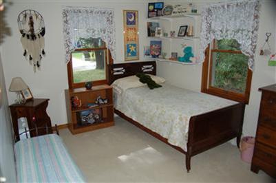 28 Deer Ridge Road Mashpee, MA 02649 - Photo 7 of 13 a bedroom with a bed a dresser next to a window