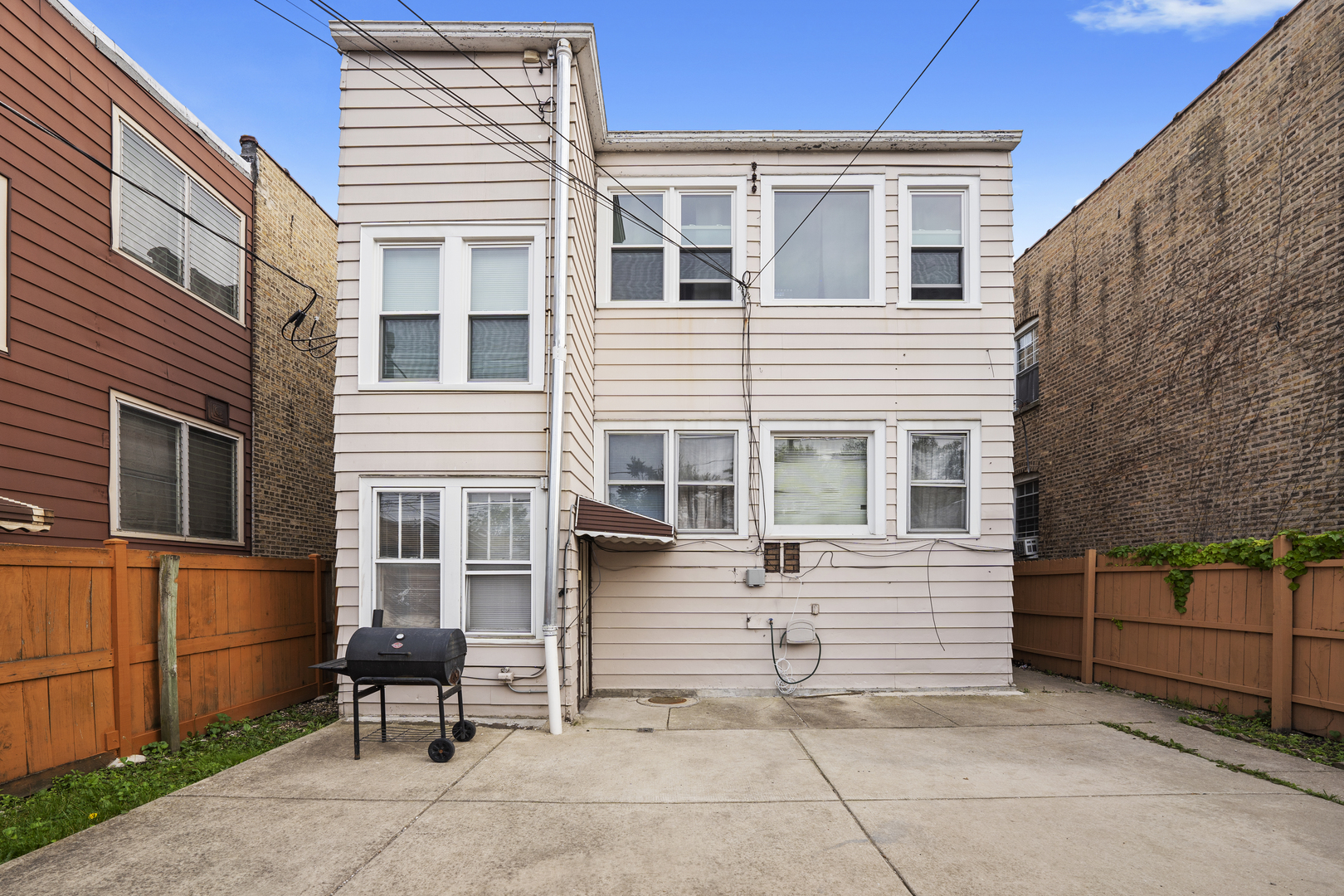 6024 West Addison Street Chicago, IL 60634 - Photo 2 of 11 a view of a house with sitting area and wooden fence