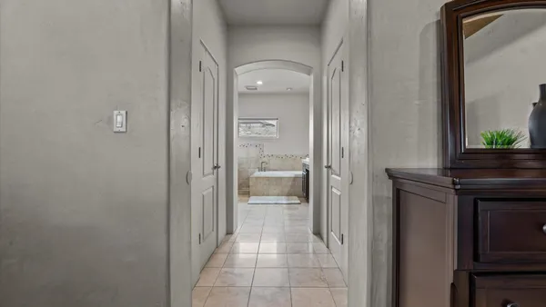 a bathroom with a bathtub double sink and a mirror