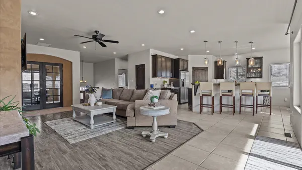 a living room with lots of furniture and kitchen view