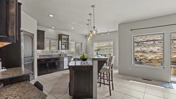 a view of a dining room with furniture and a large window