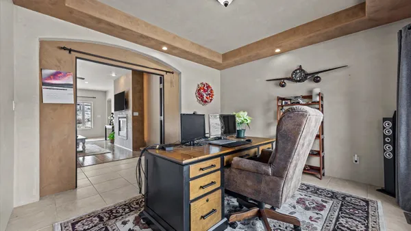 a living room with couches a fireplace and a flat screen tv