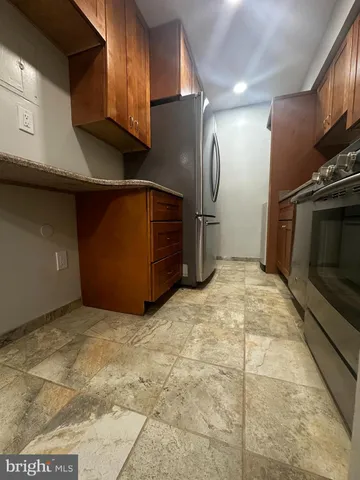 a view of a refrigerator in an empty room