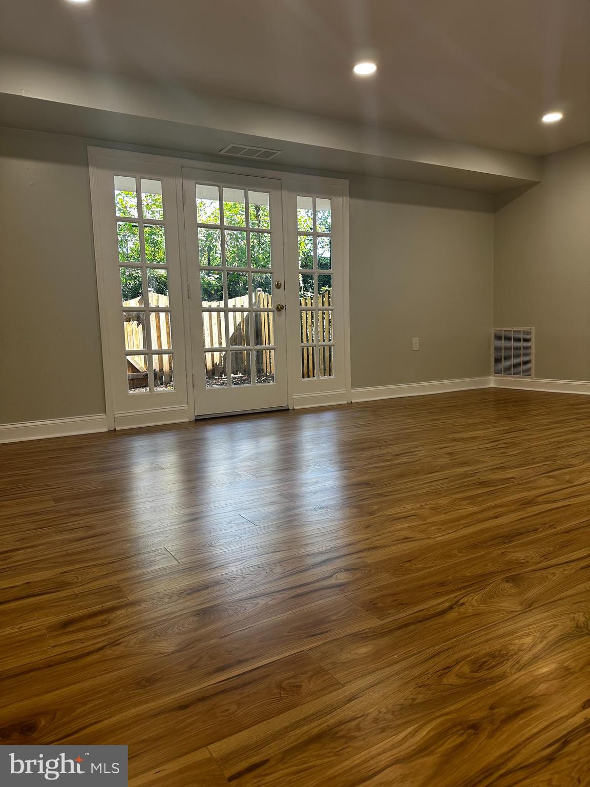 1130 South Washington Street, Unit T2 Falls Church, VA 22046 - Photo 3 of 24 a view of empty room with wooden floor and fan