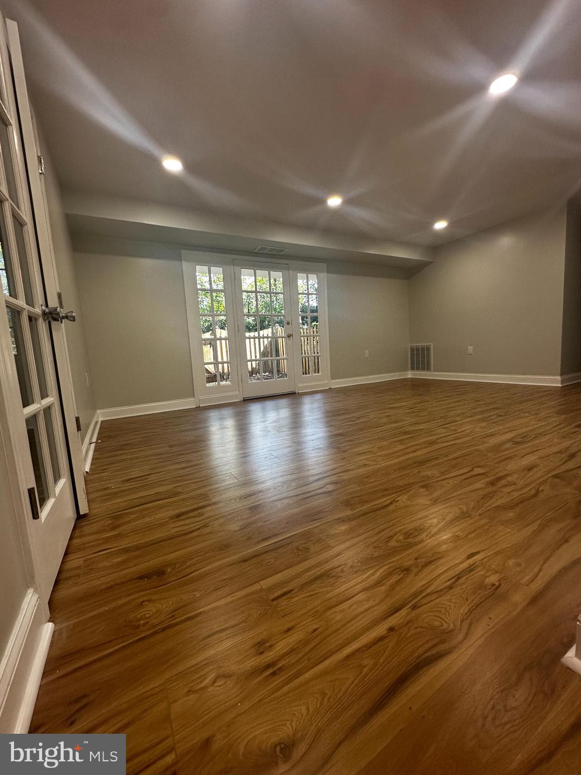 1130 South Washington Street, Unit T2 Falls Church, VA 22046 - Photo 4 of 24 an empty room with wooden floor and windows