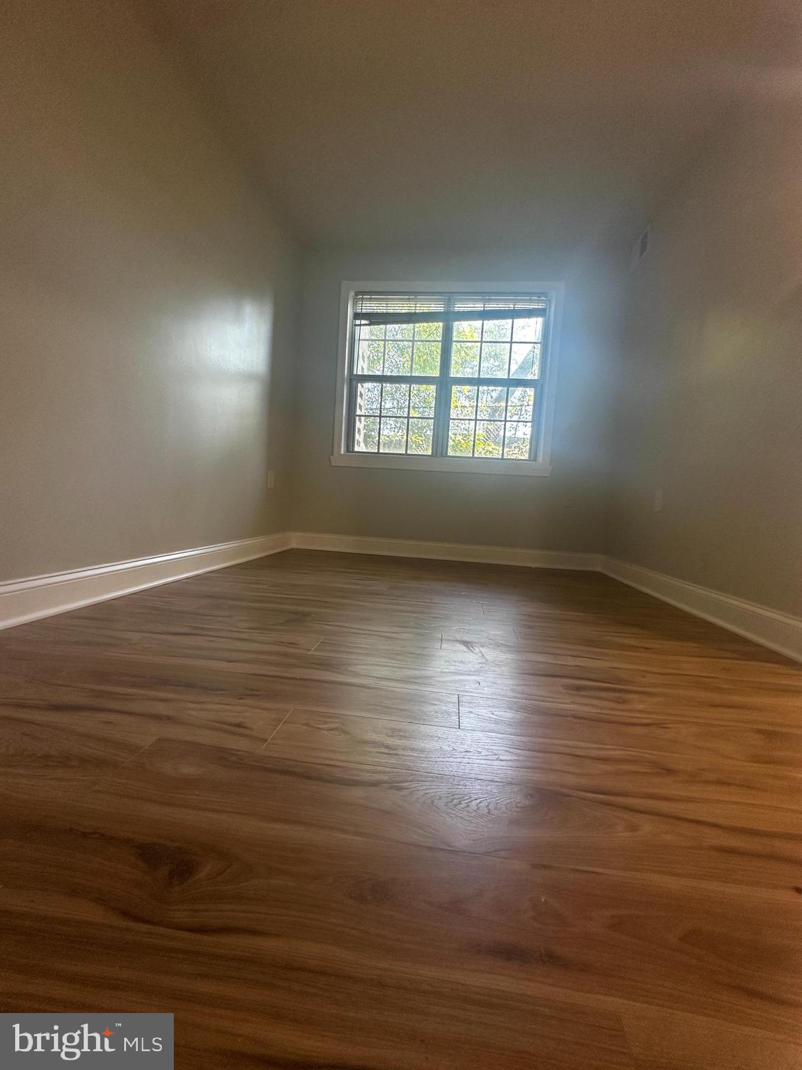 1130 South Washington Street, Unit T2 Falls Church, VA 22046 - Photo 6 of 24 an empty room with wooden floor and windows