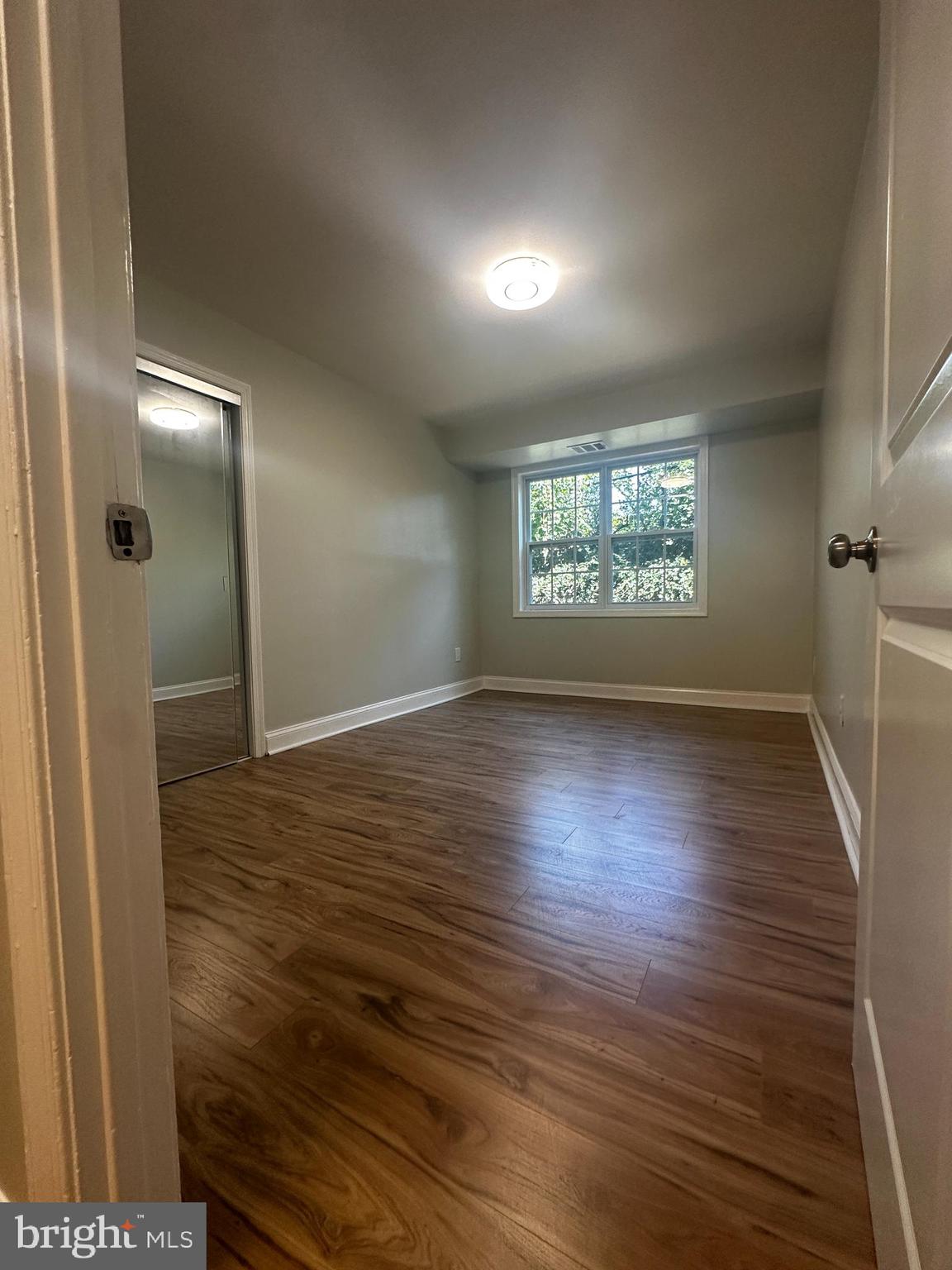 1130 South Washington Street, Unit T2 Falls Church, VA 22046 - Photo 8 of 24 an empty room with wooden floor and windows