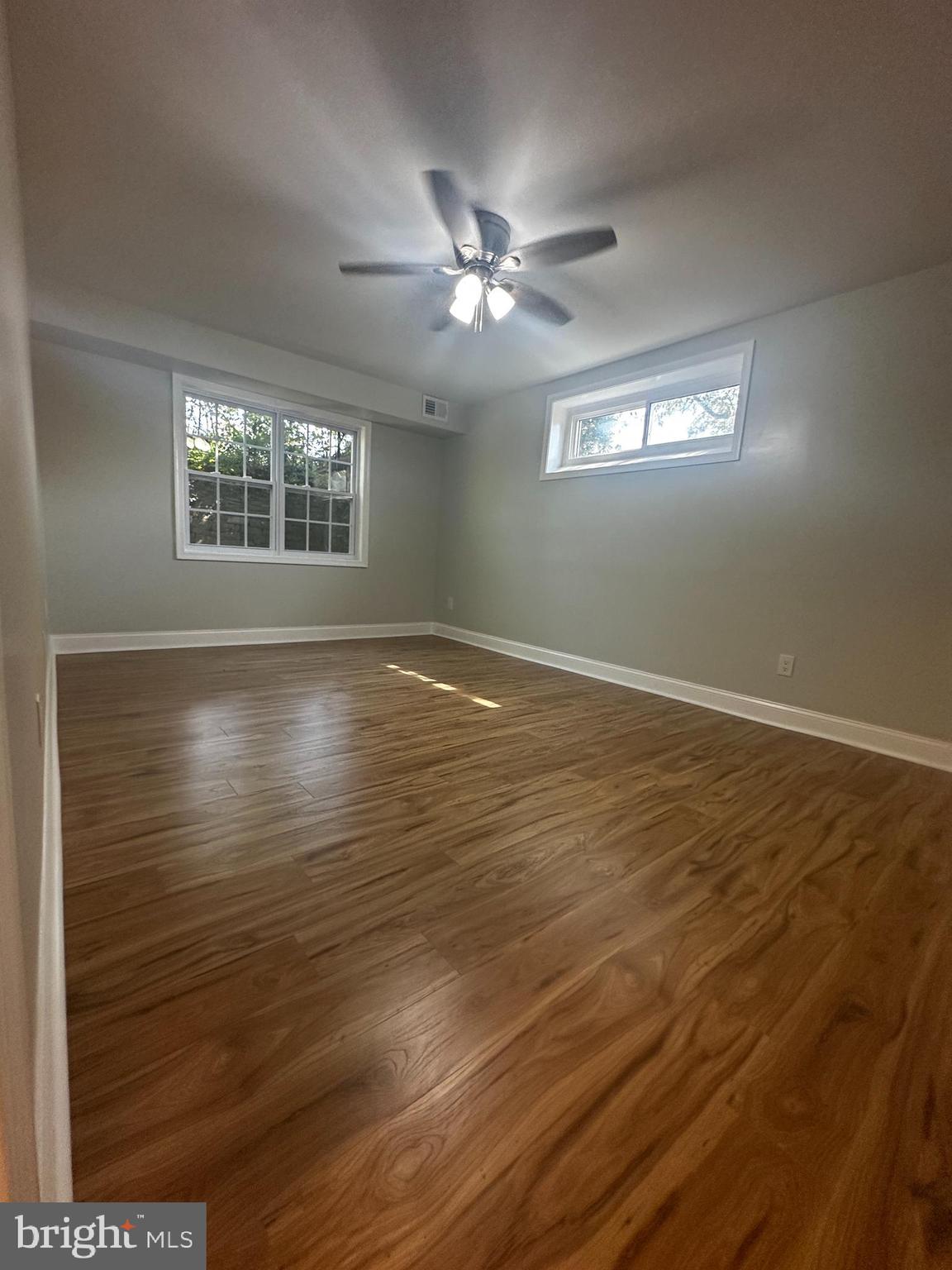 1130 South Washington Street, Unit T2 Falls Church, VA 22046 - Photo 10 of 24 a view of an empty room with wooden floor and a window