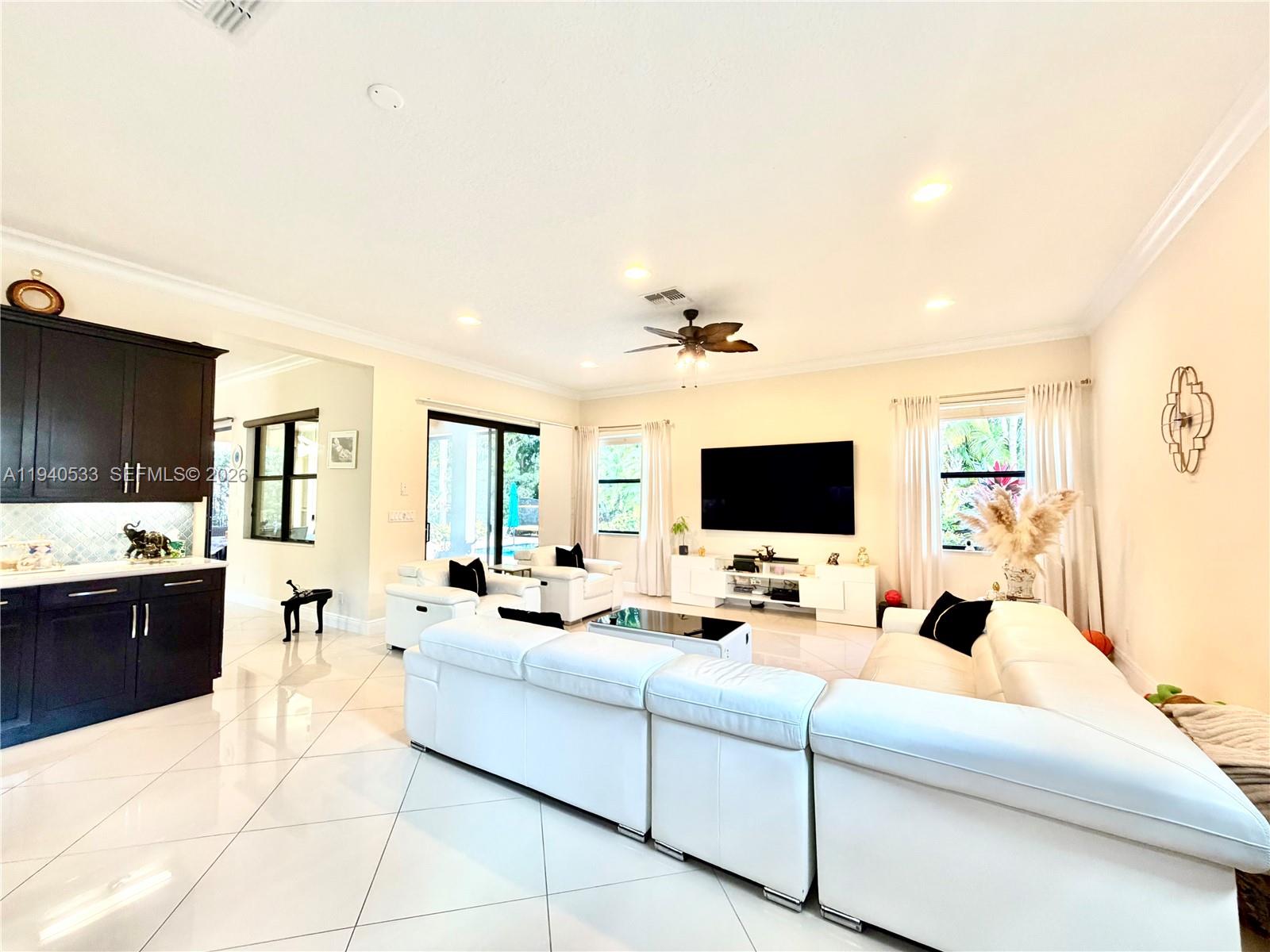 12097 Boca Reserve Lane Boca Raton, FL 33428 - Photo 15 of 54 a living room with furniture and a flat screen tv