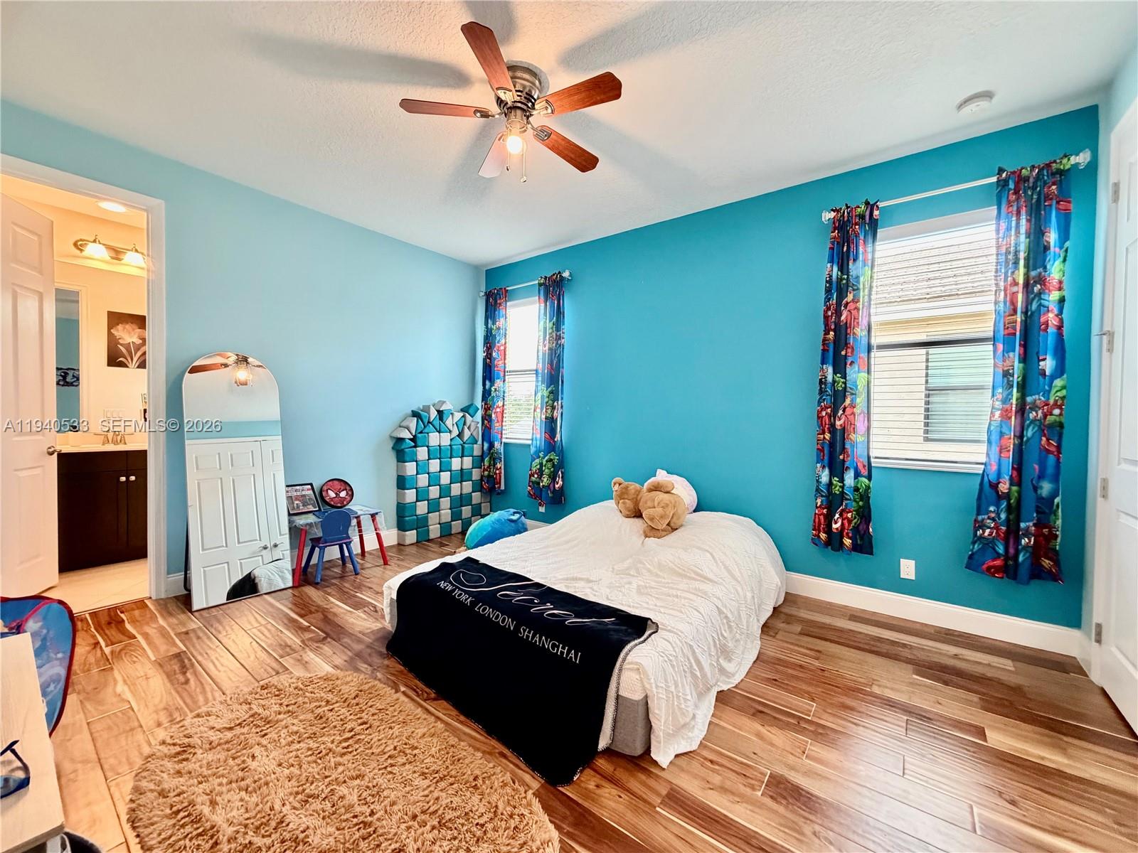 12097 Boca Reserve Lane Boca Raton, FL 33428 - Photo 33 of 54 a bedroom with a bed and a chandelier