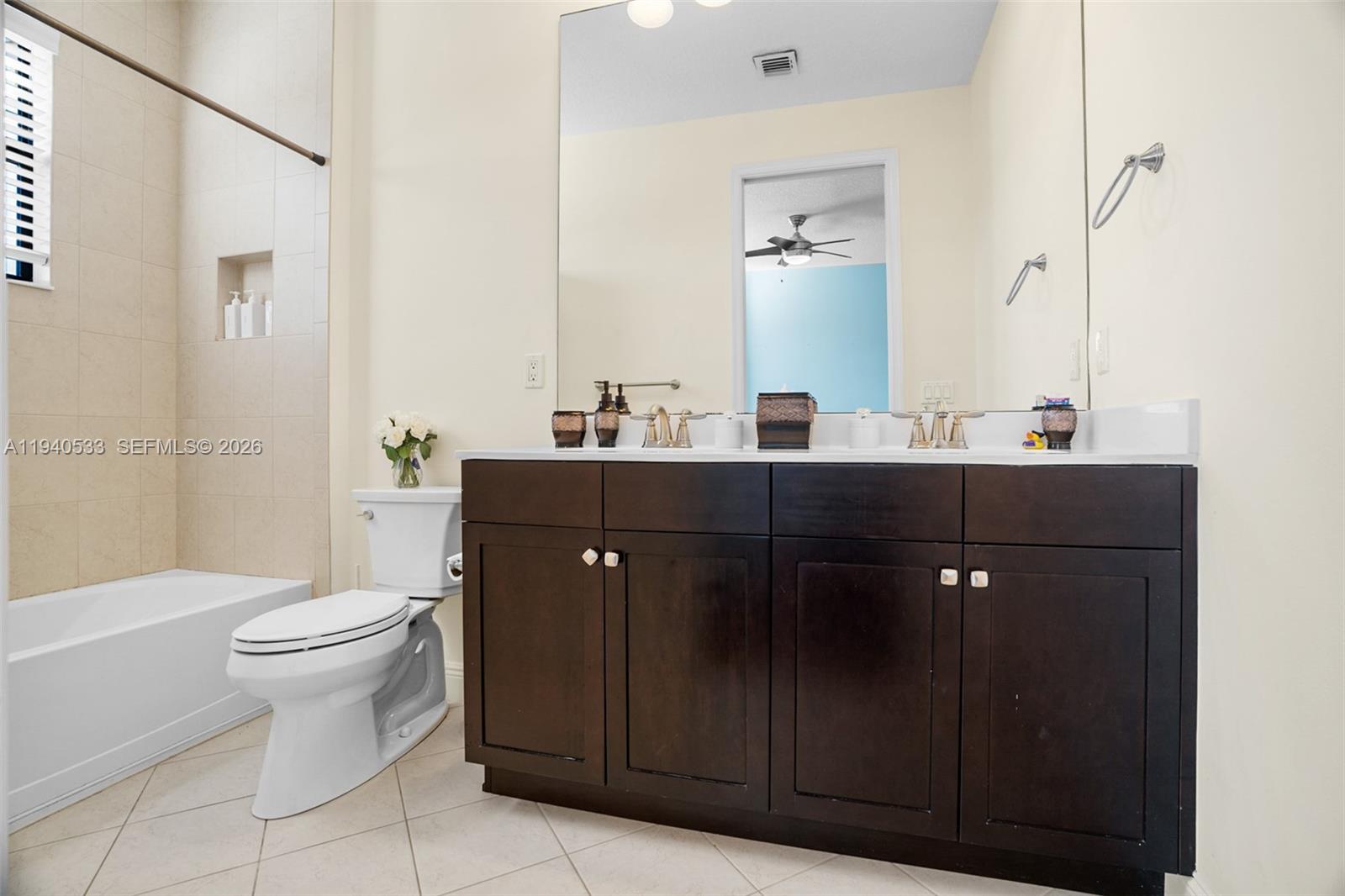 12097 Boca Reserve Lane Boca Raton, FL 33428 - Photo 37 of 54 a bathroom with a double vanity sink toilet and a mirror