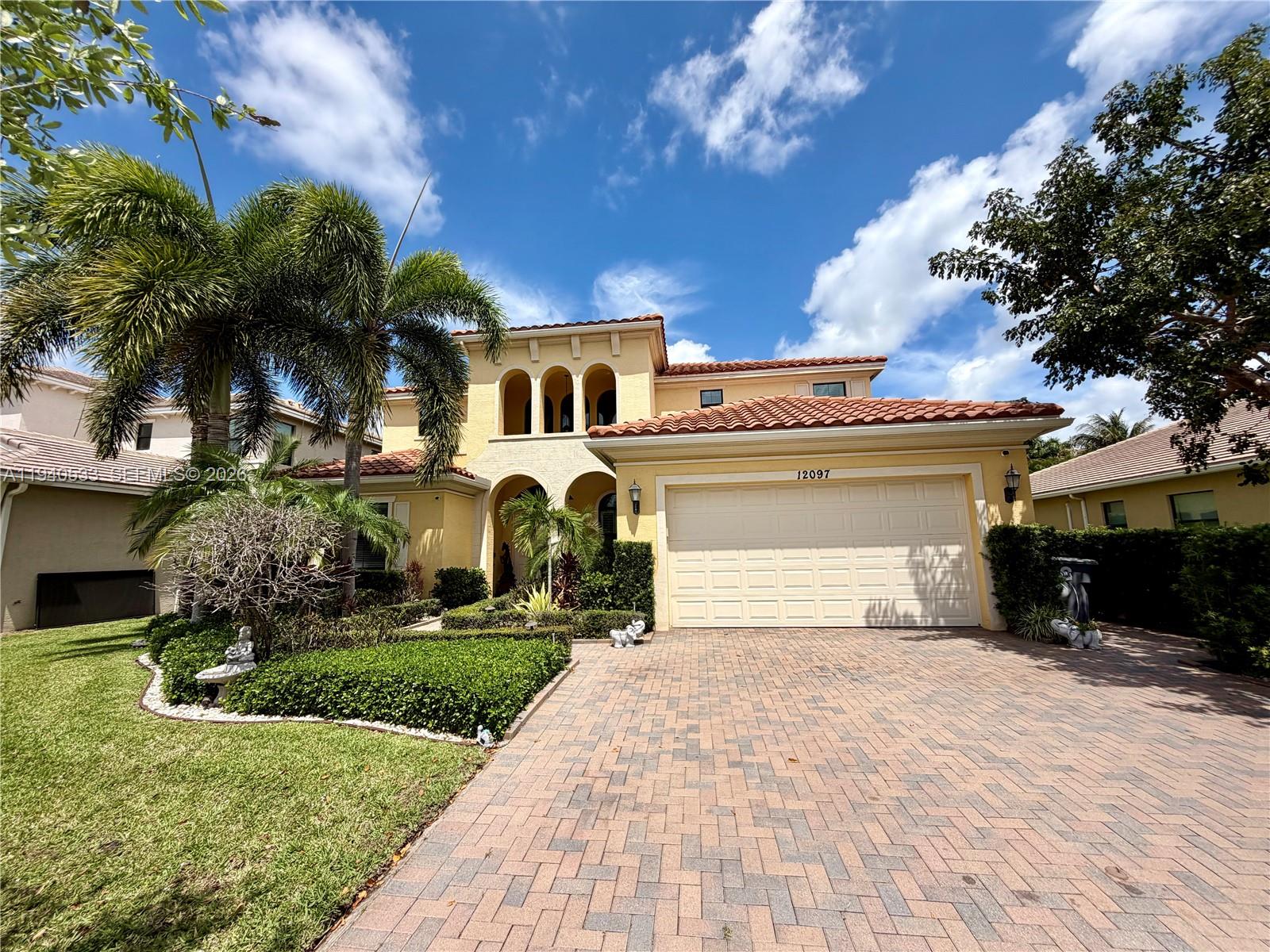 12097 Boca Reserve Lane Boca Raton, FL 33428 - Photo 53 of 54 a front view of a house with a yard and garage